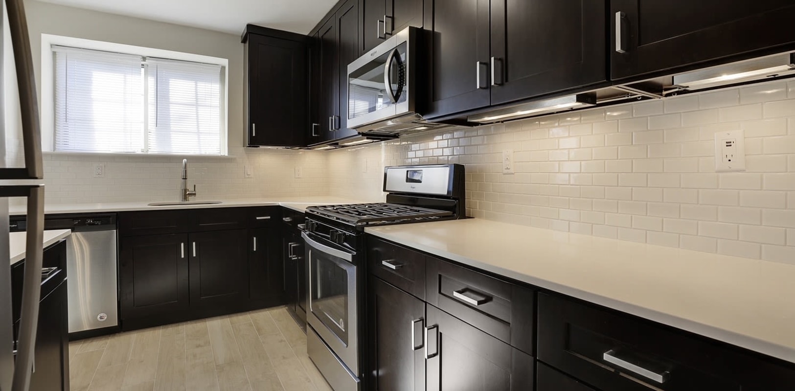 Kitchen with dark wood cabinets and ample counter space at Blair House in Morristown, New Jersey