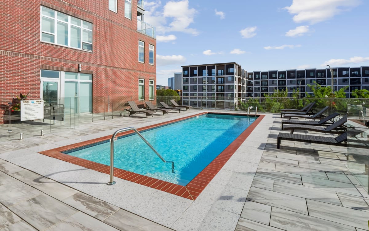 Luxurious pool with lounge chairs at Terraces at Manchester in Richmond, Virginia
