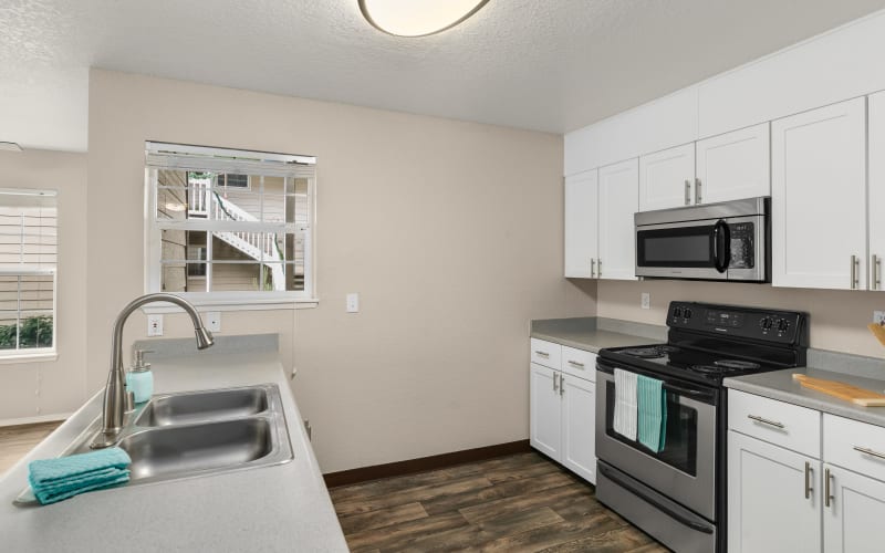 Newly renovated kitchen with white cabinets at Carriage Park Apartments in Vancouver, Washington