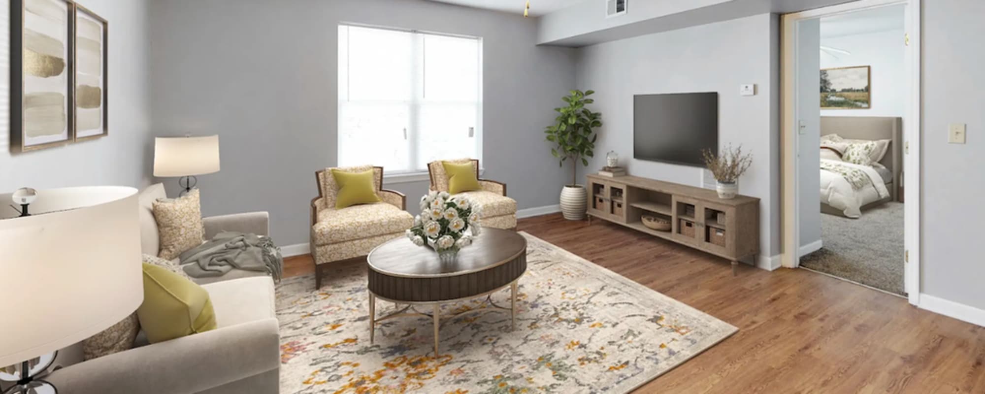 Living room with couch, chairs and flat screen television at Alston Arms Apartments in North Charleston, South Carolina