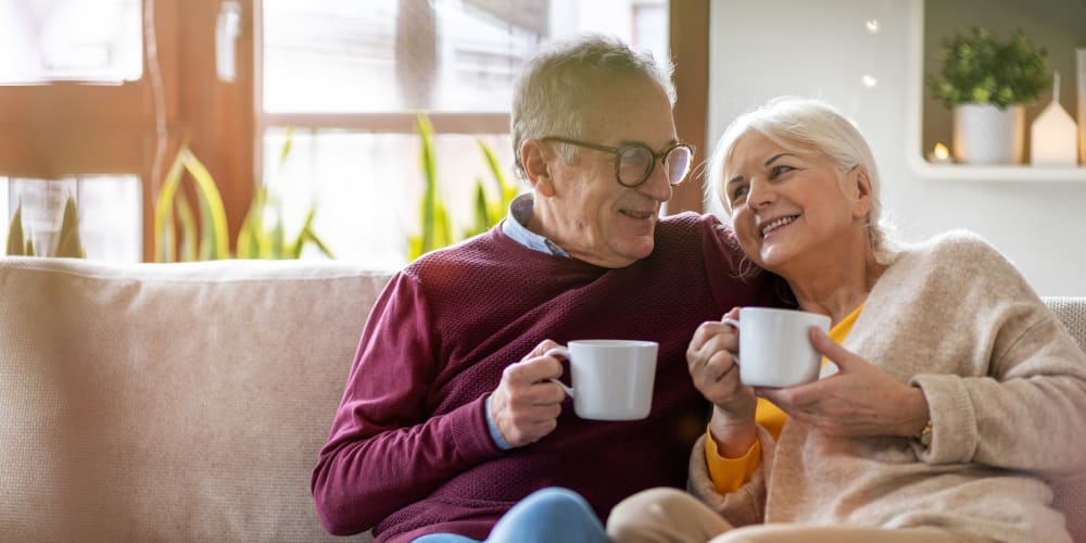 Residents sitting together on a couch with coffee at The Springs Living in McMinnville, Oregon