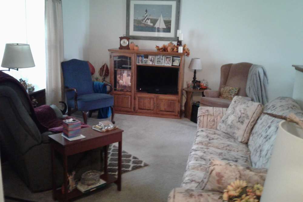 Living room with couch at Hampton Pointe Senior Living in Three Rivers. MI