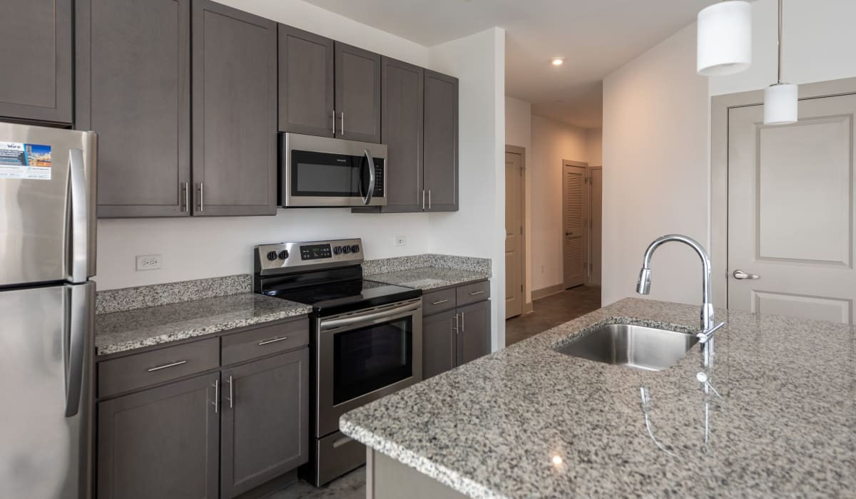 Kitchen with stinless-steel appliances and granite counter tops at The Collection at American Tobacco Center, Richmond, Virginia