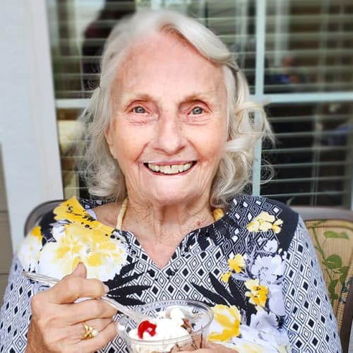 A resident enjoying an ice cream sundae at The Oxford Grand Assisted Living & Memory Care in Kansas City, Missouri