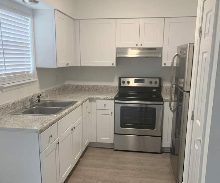 Apartment kitchen with stainless-steel appliances at Tyndall Pointe in Panama City, Florida