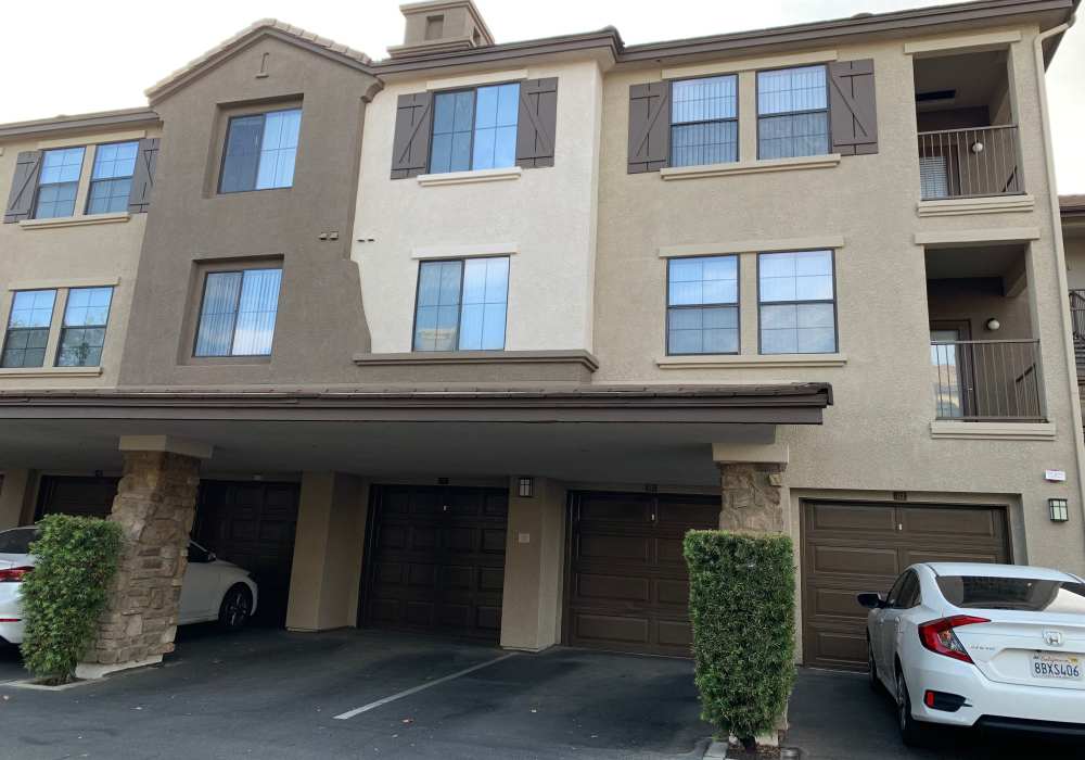 Building exterior with attached garages at Links at Westridge in Valencia, California