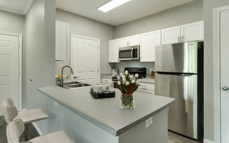 Renovated kitchen with white cabinets at The Grove at Orenco Station in Hillsboro, Oregon