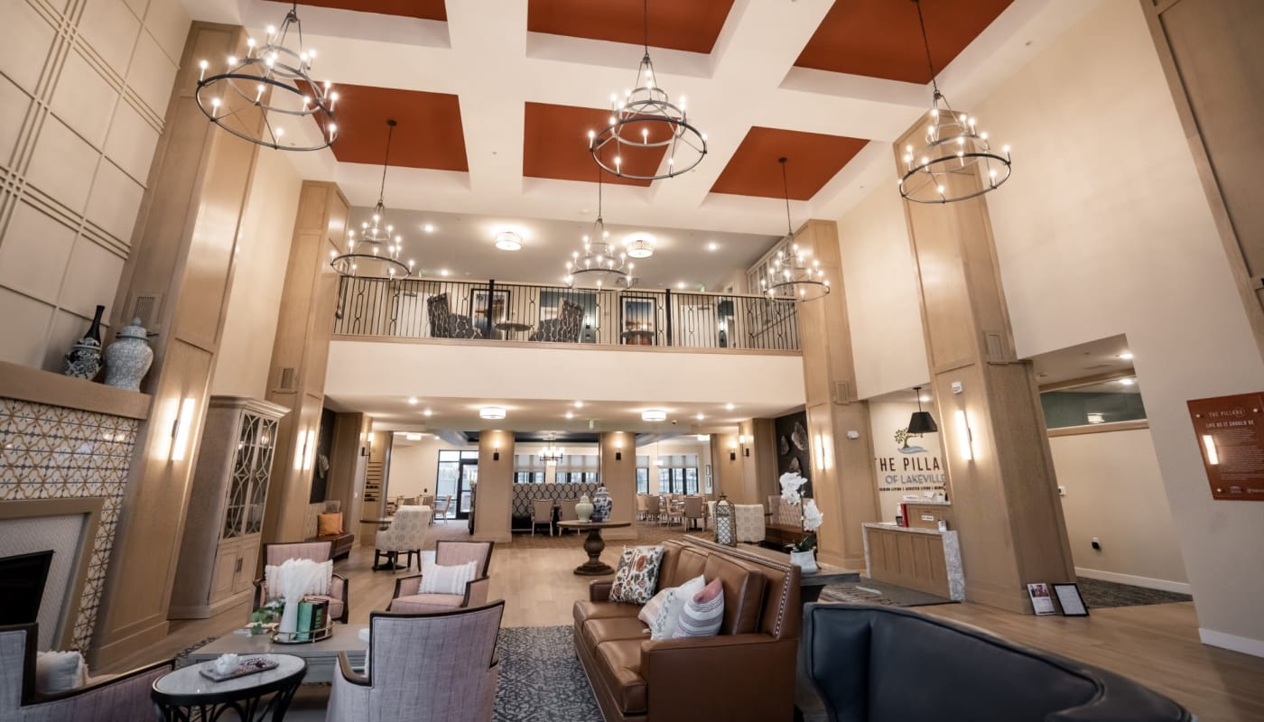 Large lobby and reception area with welcoming lounge at The Pillars of Lakeville in Lakeville, Minnesota