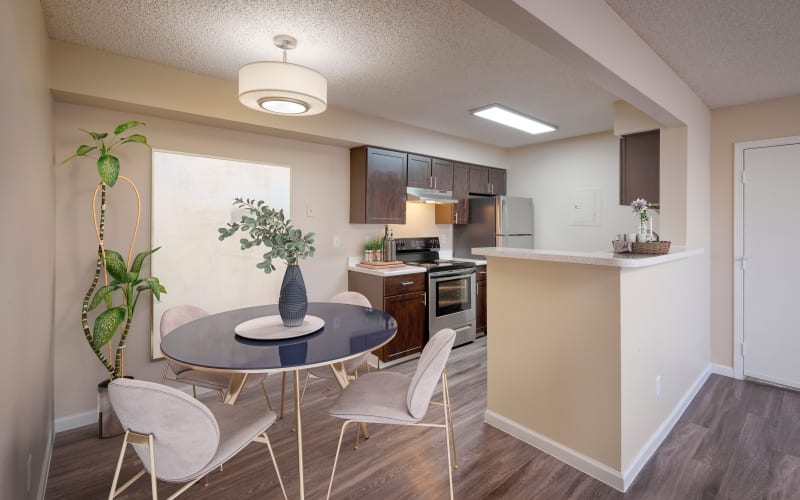 Espresso cabinets in the kitchen overlooking the dining room at Alton Green Apartments in Denver, Colorado