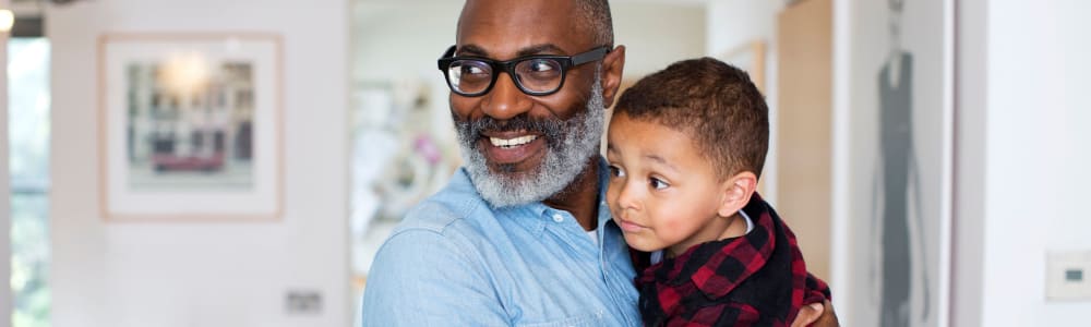 Resident holding his young grandson