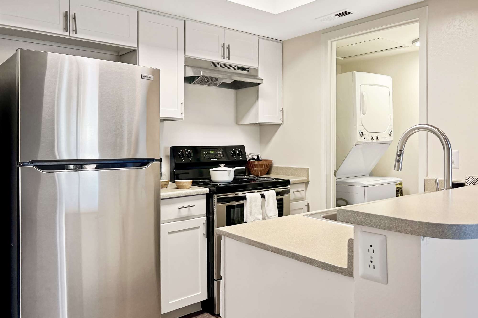 Spacious kitchen with a view into the living room at Shadowbrook Apartments in West Valley City, Utah