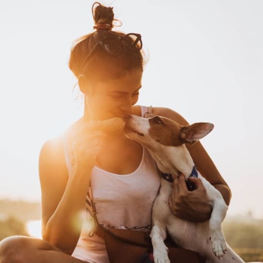 Resident feeding her dog at Bayfair Apartments in San Lorenzo, California