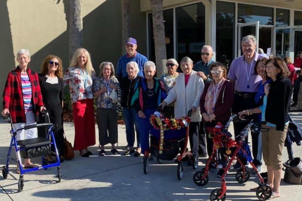 Residents outside a building near Inspired Living Sarasota in Sarasota, Florida