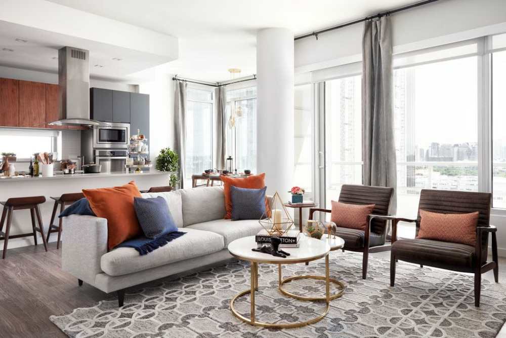 Spacious living room along with entry to open kitchen at Ardan in Dallas, Texas