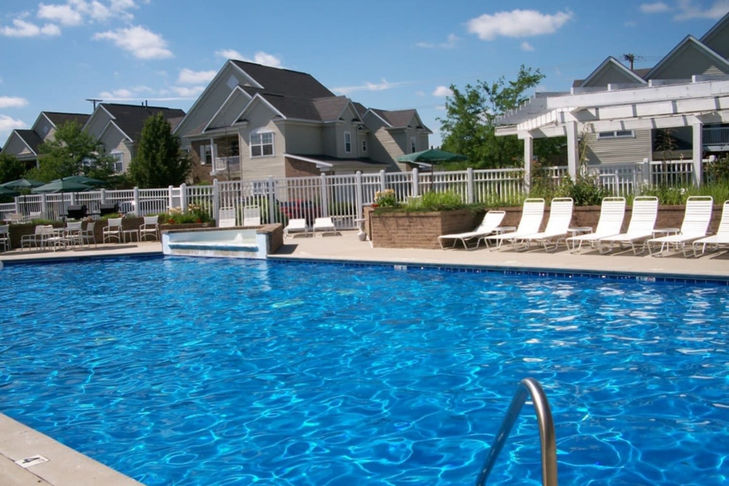 Swimming pool and lounge chairs at Avalon at Northbrook Apartments & Townhomes in Fort Wayne, Indiana