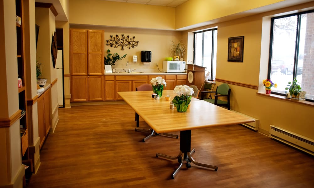 Dining area with kitchenette at East Troy Manor in East Troy, Wisconsin