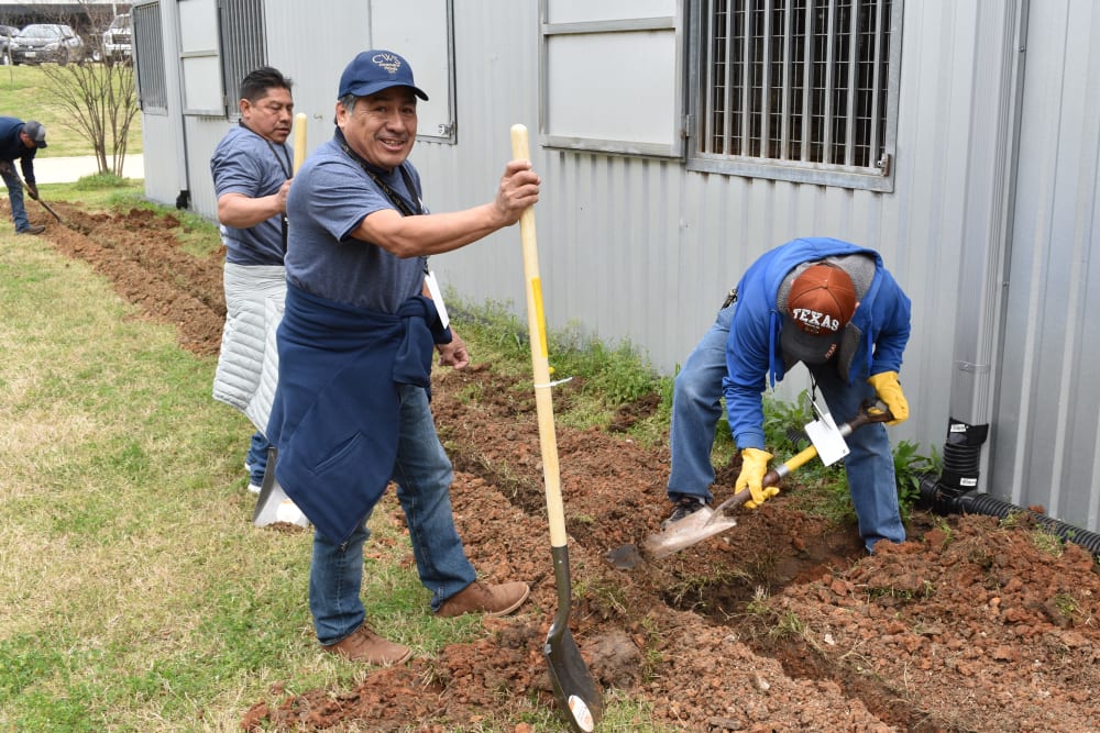 Team members digging at a property owned by CWS Apartment Homes in Austin, Texas