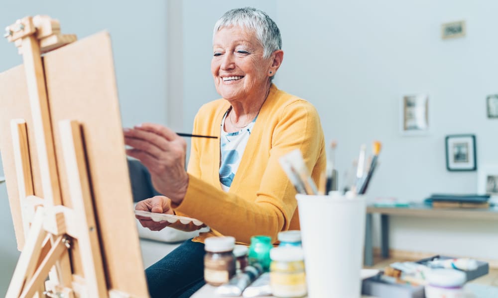 Resident painting in a studio at a Randall Residence community