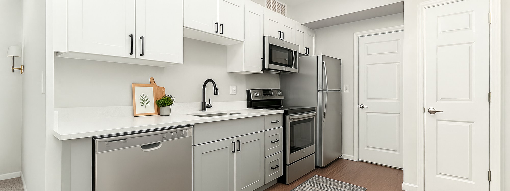 Modern kitchen with wood-style flooring at Mazza Grandmarc in College Park, Maryland