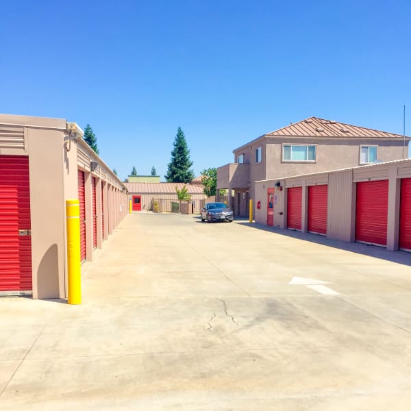 Outdoor storage units with red doors at StorQuest Express Self Service Storage in Sacramento, California