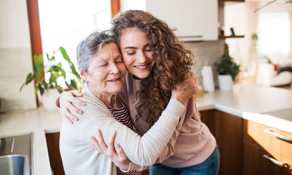 A resident hugging her grandchild at Brightwater Senior Living of Linden Ridge in Winnipeg, Manitoba