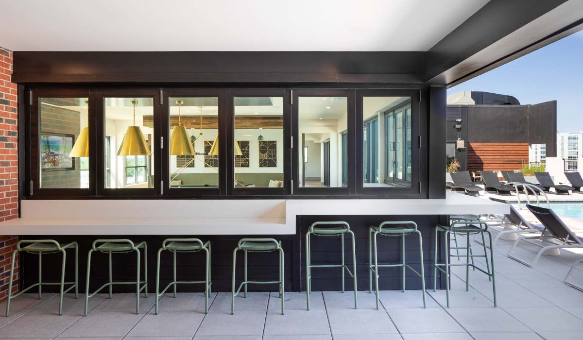 Outdoor kitchen area by the pool at Venable Durham Apartments in Durham, North Carolina