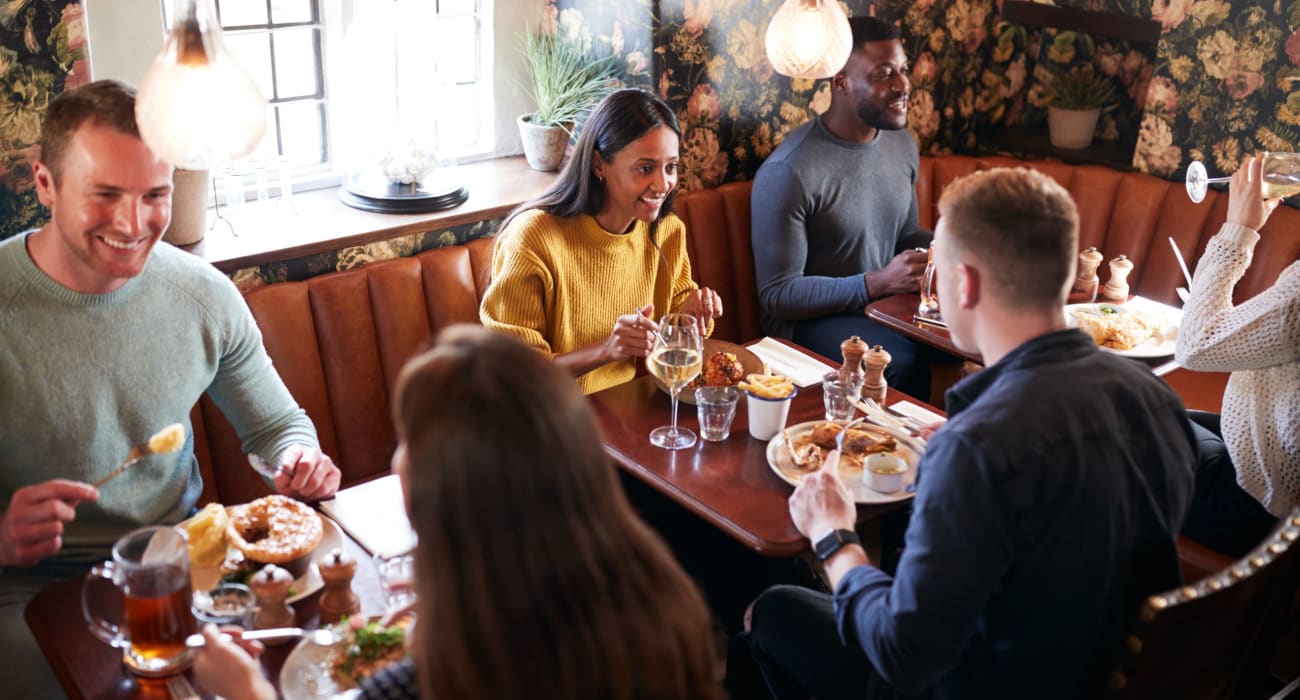 Friends exploring lunch together at a local restaurant in Ridgewood, New Jersey near Mayflower Apartments