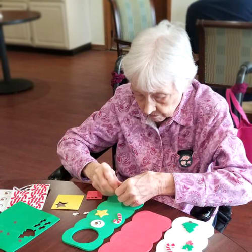 A resident making door hangers at Creekside Village in Ponca City, Oklahoma