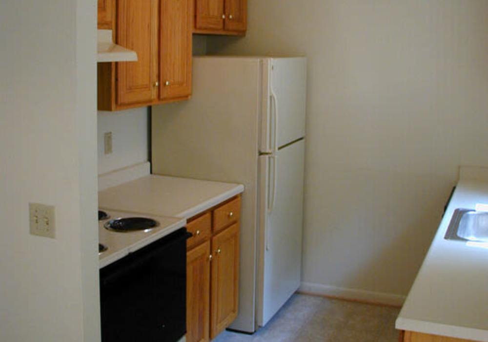 Cozy kitchen with wood-style flooring at Jefferson Manor Townhomes in Fairport, New York 