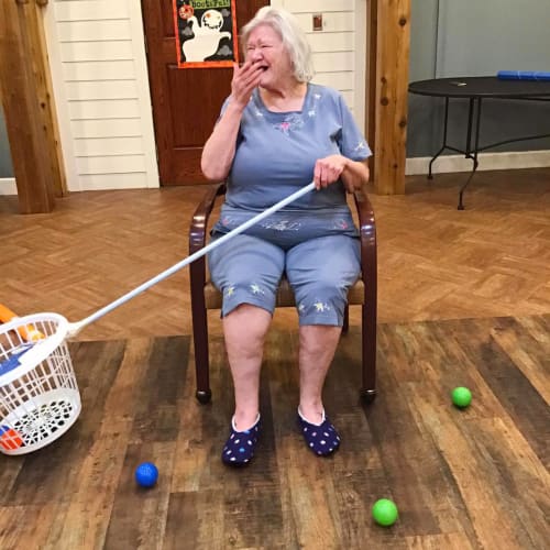 Resident playing a game at Oxford Glen Memory Care at Owasso in Owasso, Oklahoma