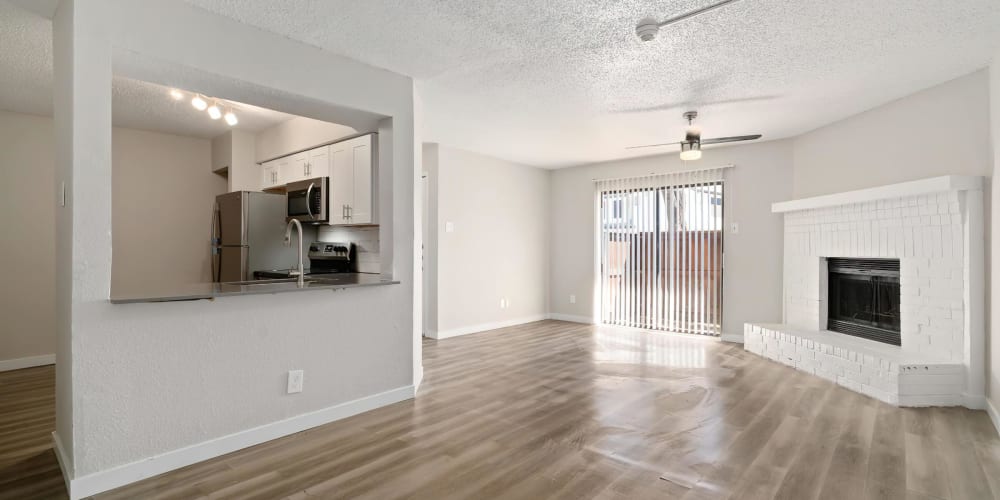 Apartment with wood-style flooring and a fireplace at Tides at Meadowbrook in Fort Worth, Texas