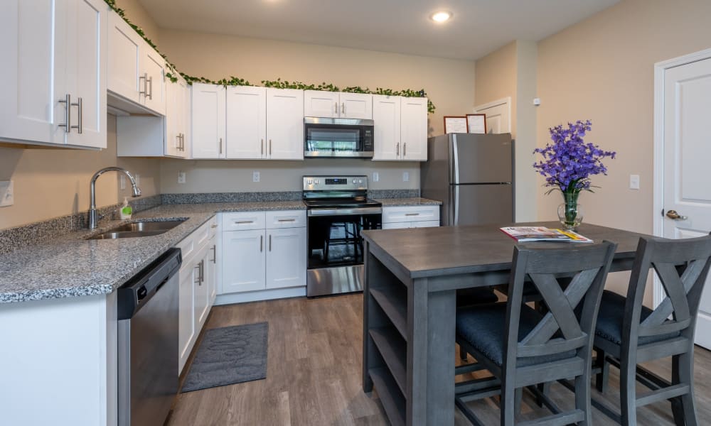 Beautiful eat-in kitchen with hardwood floors and granite counters at Forest Ridge Villas in Kansas City, Missouri