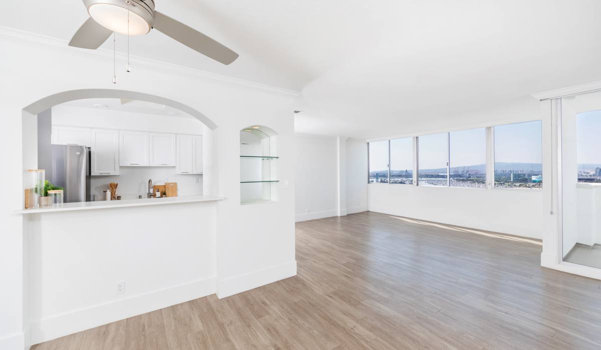 Cozy kitchen with white tone and a beach view at 1900 Ocean Apartment Homes in Long Beach,