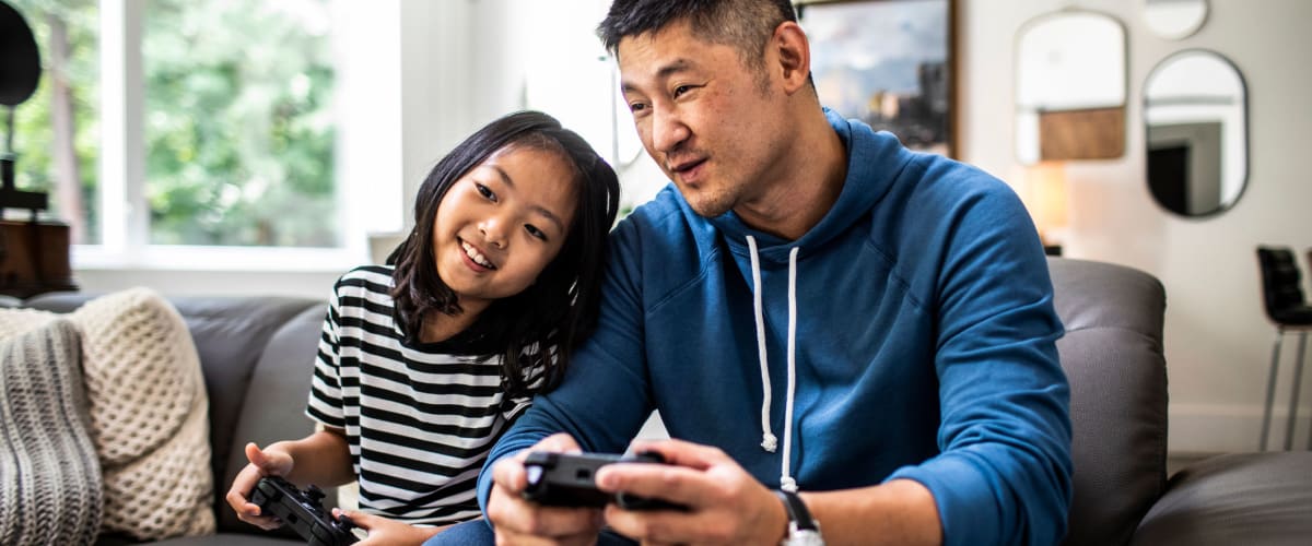 Father playing video games with daughter at Solaire 1150 Ripley in Silver Spring, Maryland