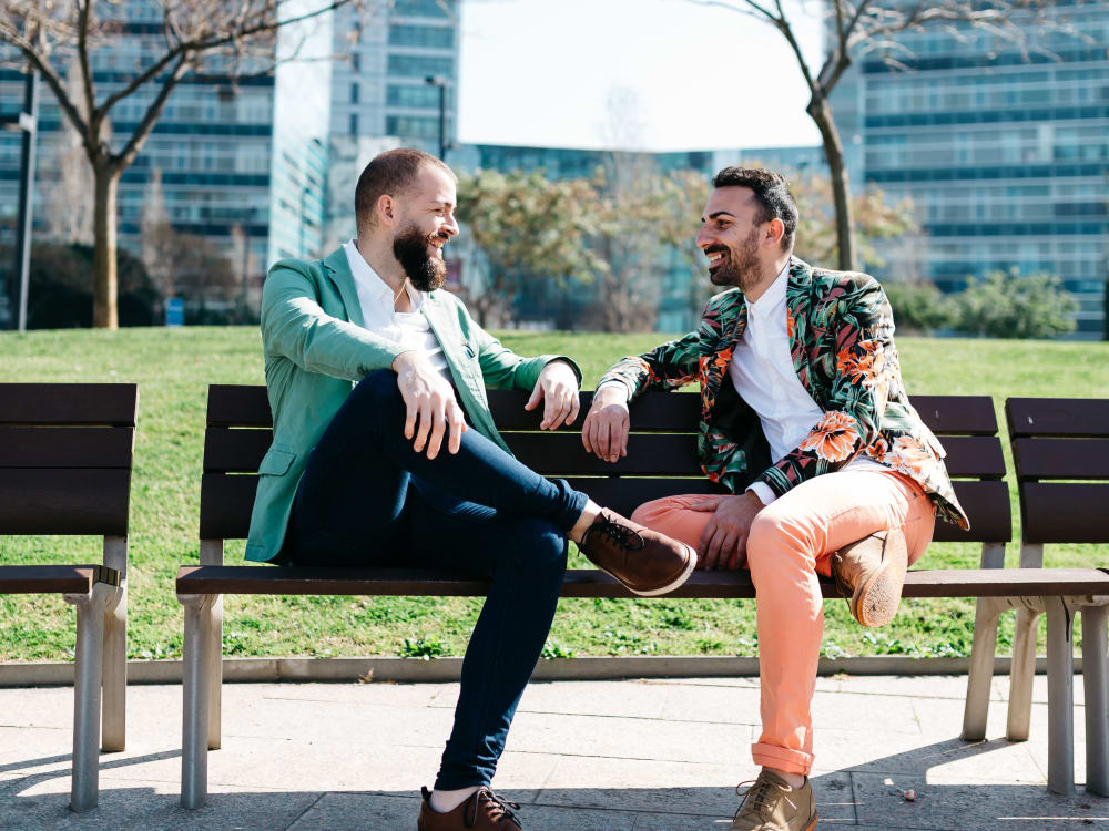 Residents chatting on a bench at a park near Sofi Belmont Hills in Belmont, California