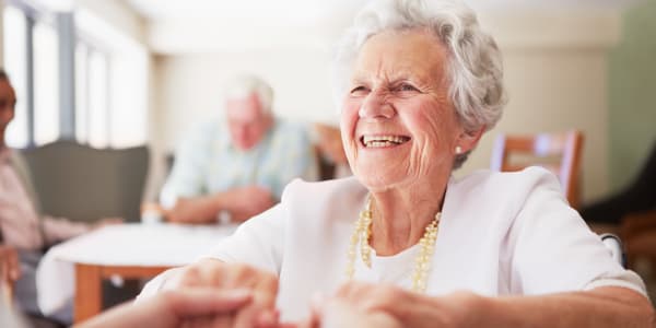 Happy resident holding hands with her child at Holton Manor in Elkhorn, Wisconsin