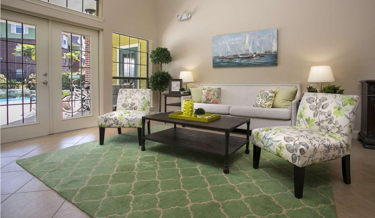 Modern living room with green carpet at Summerwood in Tyler, Texas