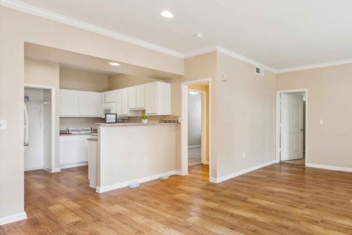 Spacious living room view along with kitchen at Brazoswood Apartments in Clute, Texas