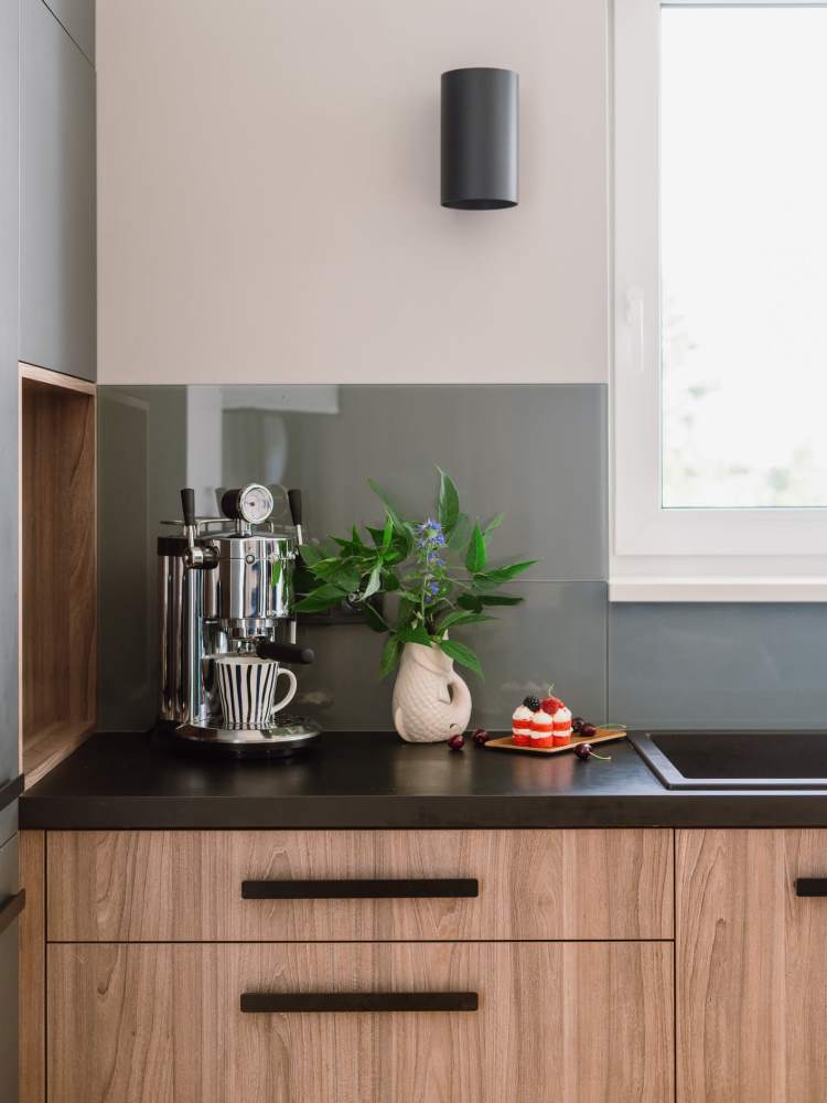 Kitchen with solid countertop and wood-grained cupboards at The Colton in Redwood City, California
