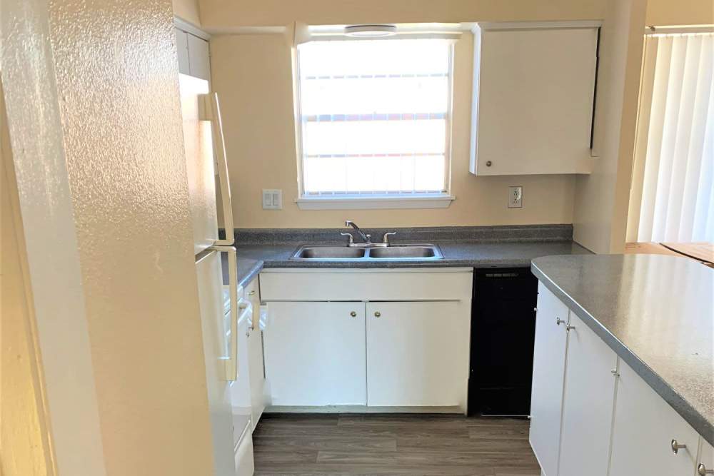 Kitchen with stainless-steel sink and wooden cabinets at Sagewood in El Paso, Texas