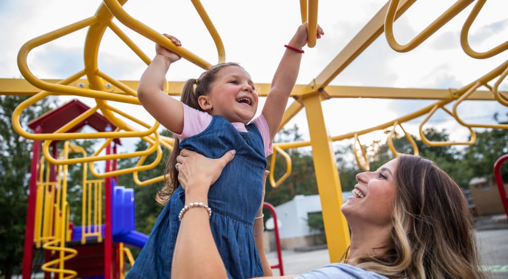 A family enjoys time at the playground Brentwood Apartments in Painesville, Ohio