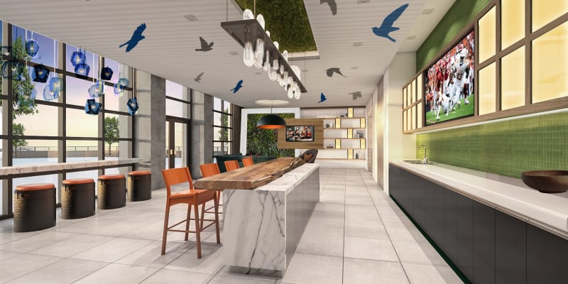 Resident lounge with bar seating and floor-to-ceiling windows at Solaire 8200 Dixon in Silver Spring, Maryland