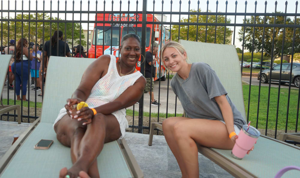 Two ladies being happy at Emerald Pointe Apartment Homes in Harvey, Louisiana