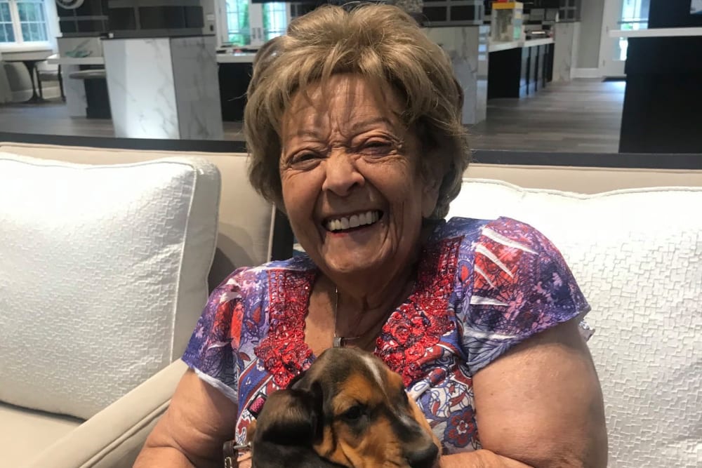 Resident holding a puppy at Blossom Ridge in Oakland Charter Township, Michigan