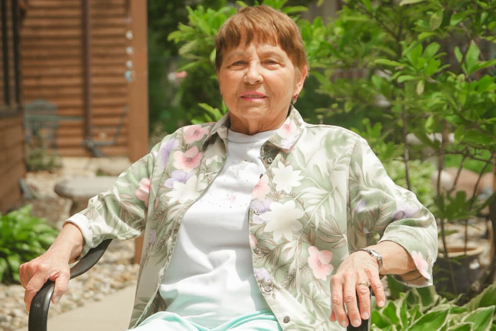 Resident enjoying the sun in the garden at Garnett Place in Cedar Rapids, Iowa.