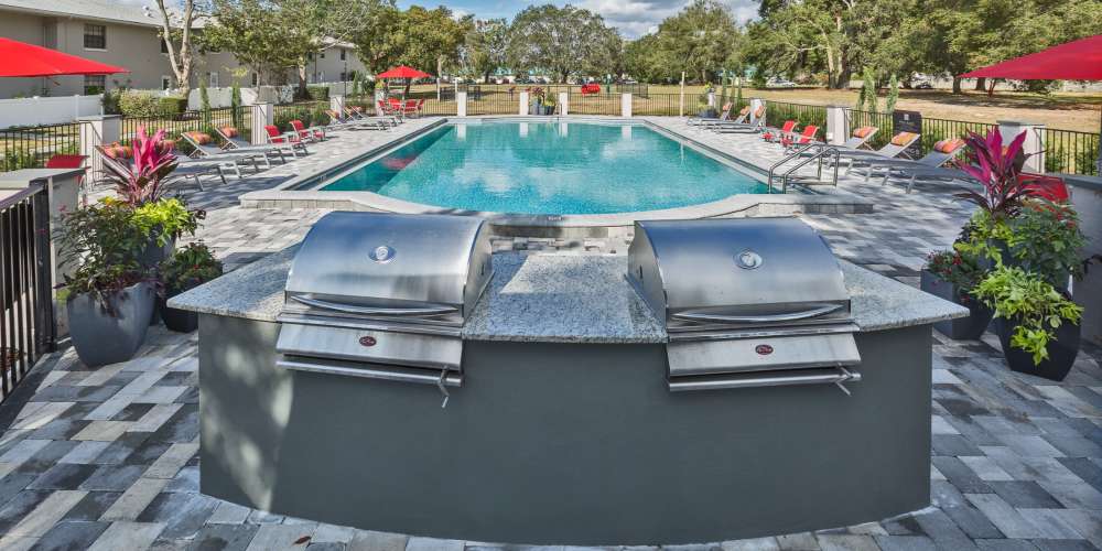 Outdoor grills by the pool at Barrington Place at Winter Haven in Winter Haven, Florida