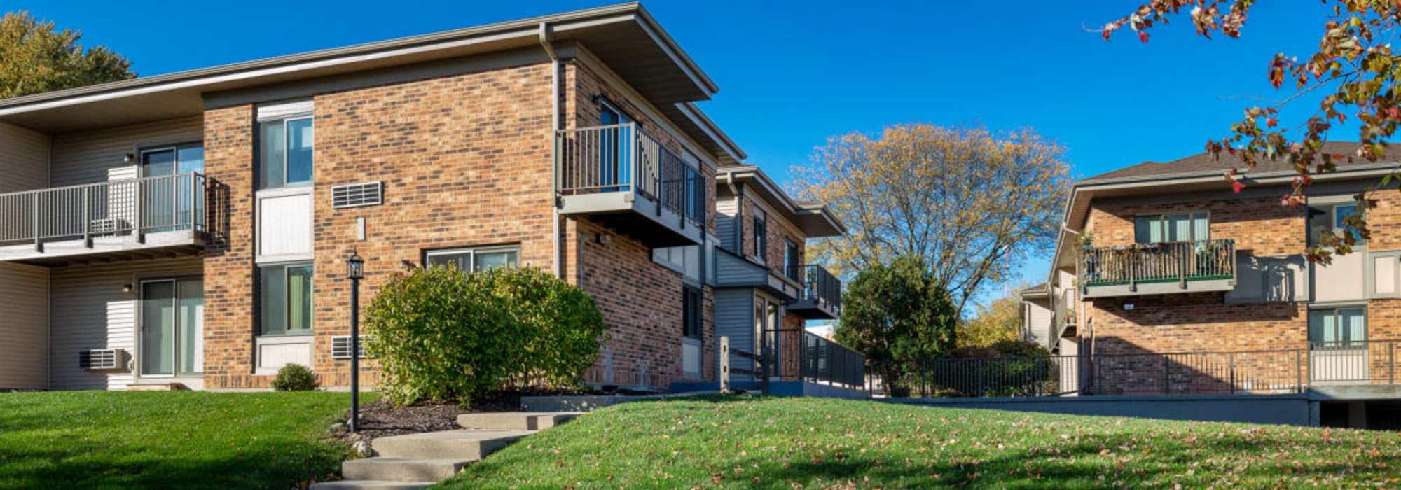 Exterior view of apartments surrounded by green landscape at Schroeder Square Apartments in Madison, Wisconsin