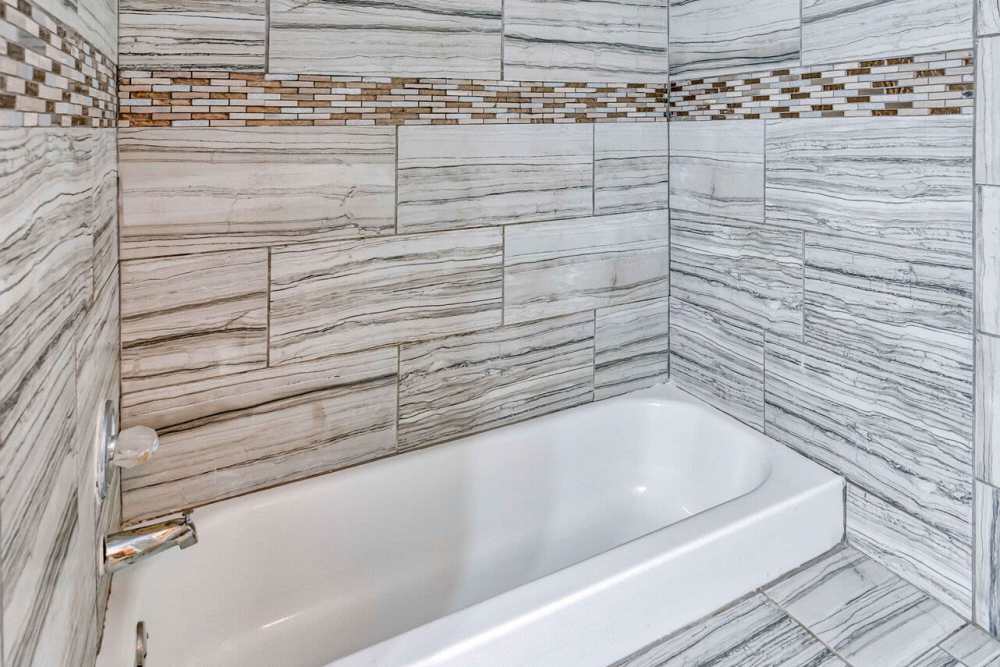 Bright bathroom with standard bathtub at Stoneridge in Kilgore, Texas