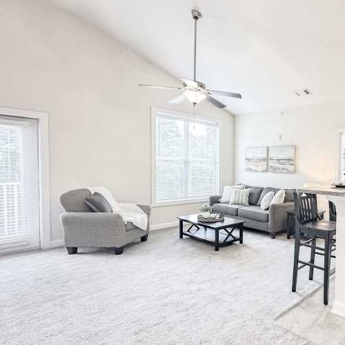 Spacious living room with couch and coffee table at South Fork Village in Belmont, North Carolina