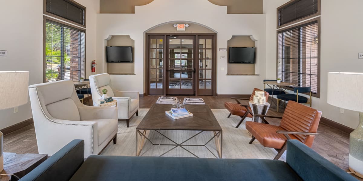 Community clubhouse lounge area with large screen television monitors at Marquis at Sonoran Preserve in Phoenix, Arizona